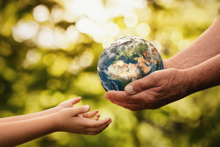 getty Senior Hands Giving Small Planet Earth To A Child